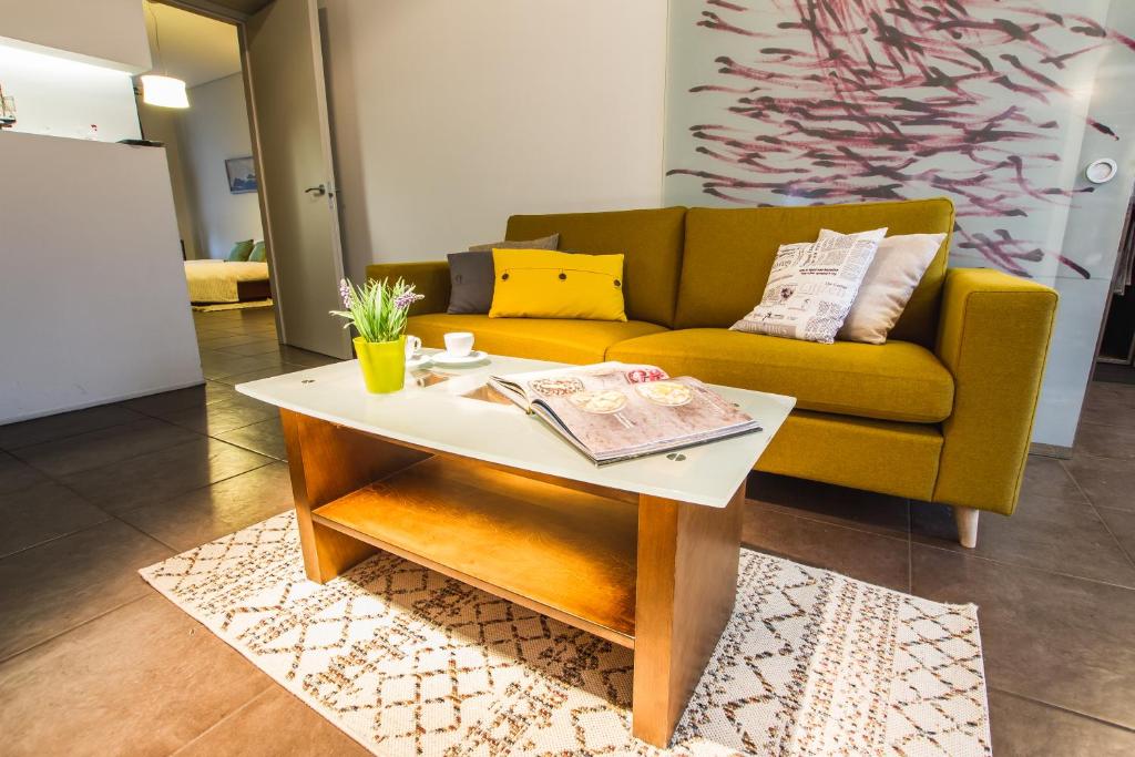 a living room with a couch and a coffee table at SPACIOUS 3 ROOM CENTRAL APARTMENT 56d in Kaunas