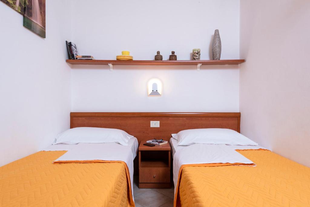 Postel nebo postele na pokoji v ubytování OasiMaremma Village