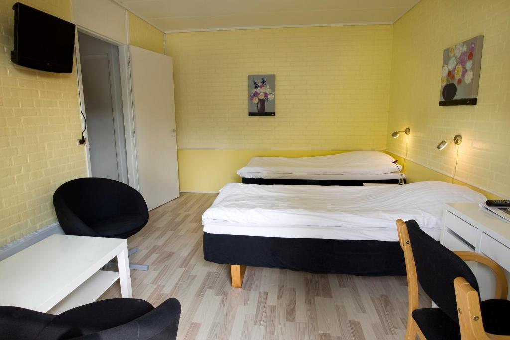 Postel nebo postele na pokoji v ubytování Hotel Troense