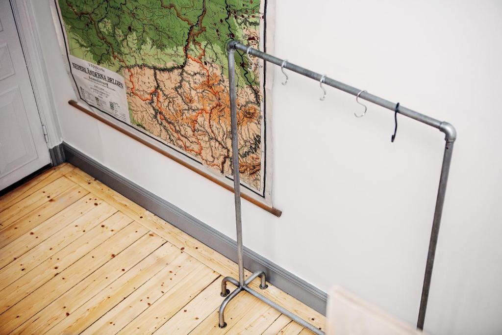 a map hanging on a wall next to a pole at City Backpackers Hostel in Stockholm