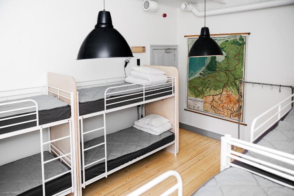 a room with bunk beds and a map on the wall at City Backpackers Hostel in Stockholm