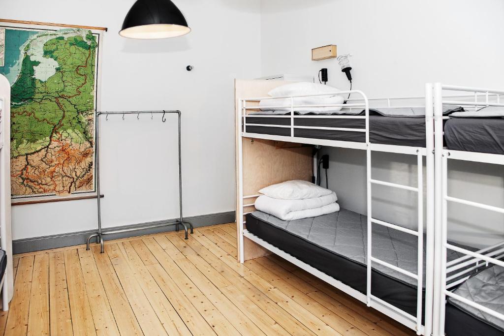 a room with bunk beds and a map on the wall at City Backpackers Hostel in Stockholm
