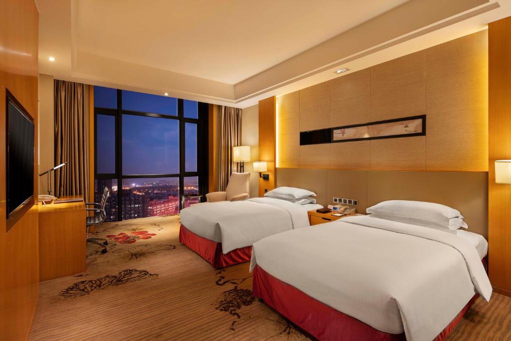 Postel nebo postele na pokoji v ubytování Wyndham Shanghai Nanxiang