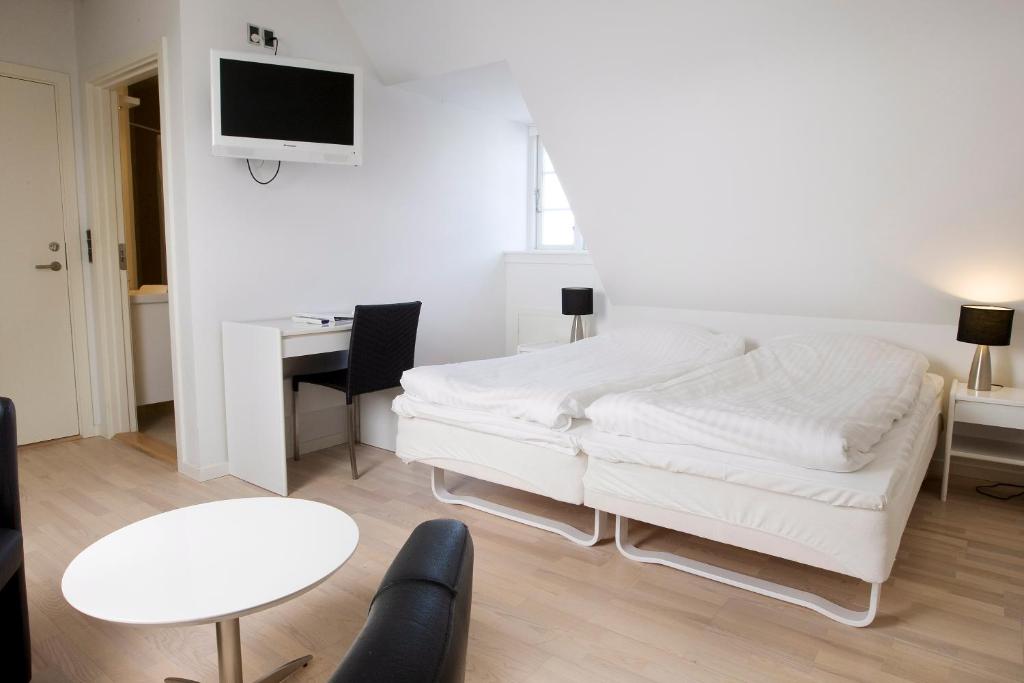 Postel nebo postele na pokoji v ubytování Hotel Troense