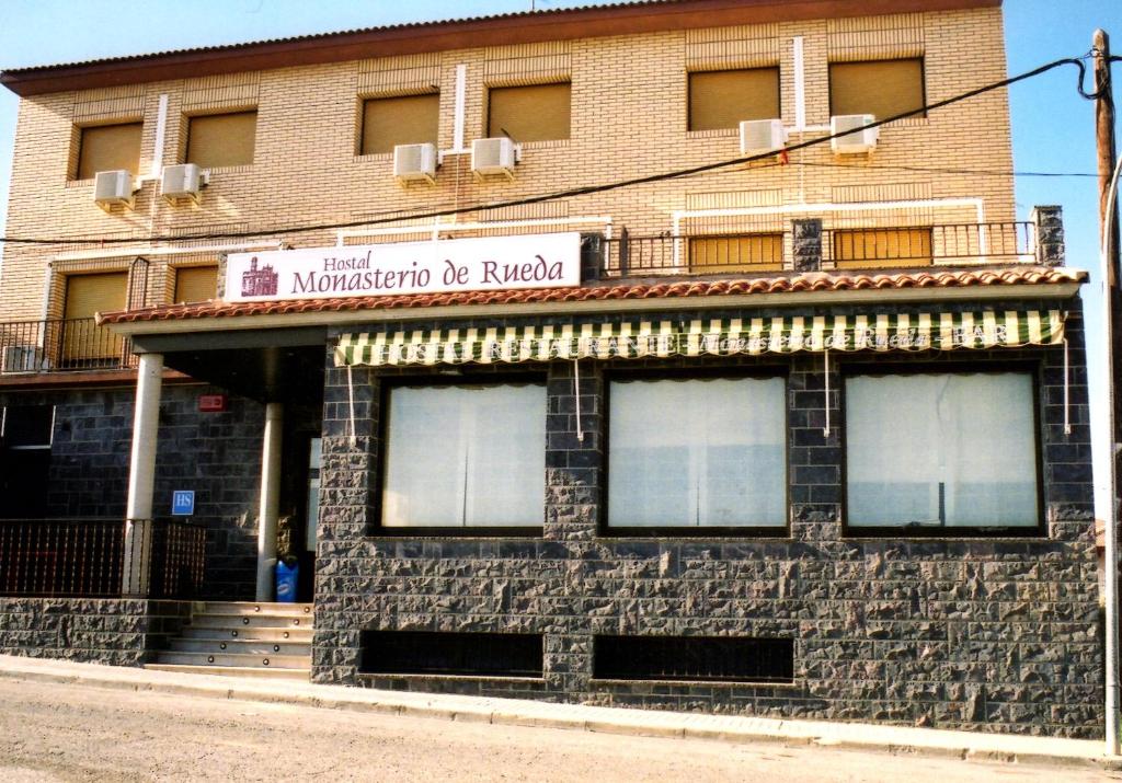 a building on the corner of a street at Hostal Monasterio de Rueda in Sástago