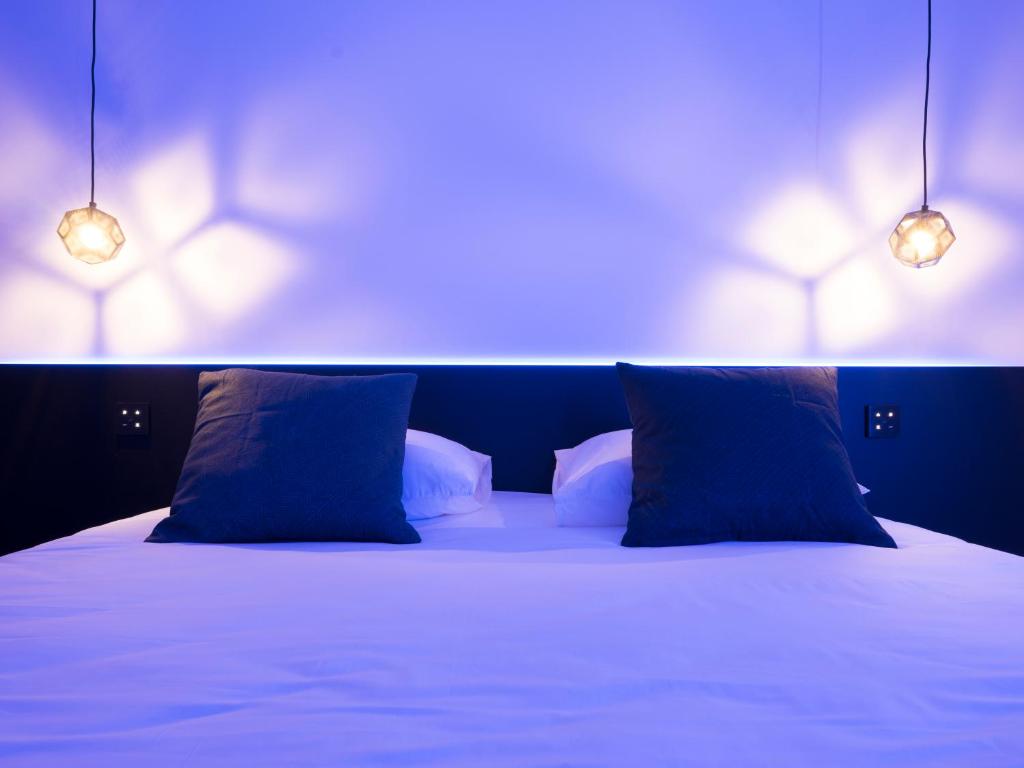 Postel nebo postele na pokoji v ubytování MiHotel Vieux Lyon