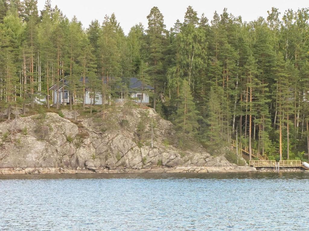 a house on the shore of a body of water at Holiday Home Nestori by Interhome in Vuoriniemi