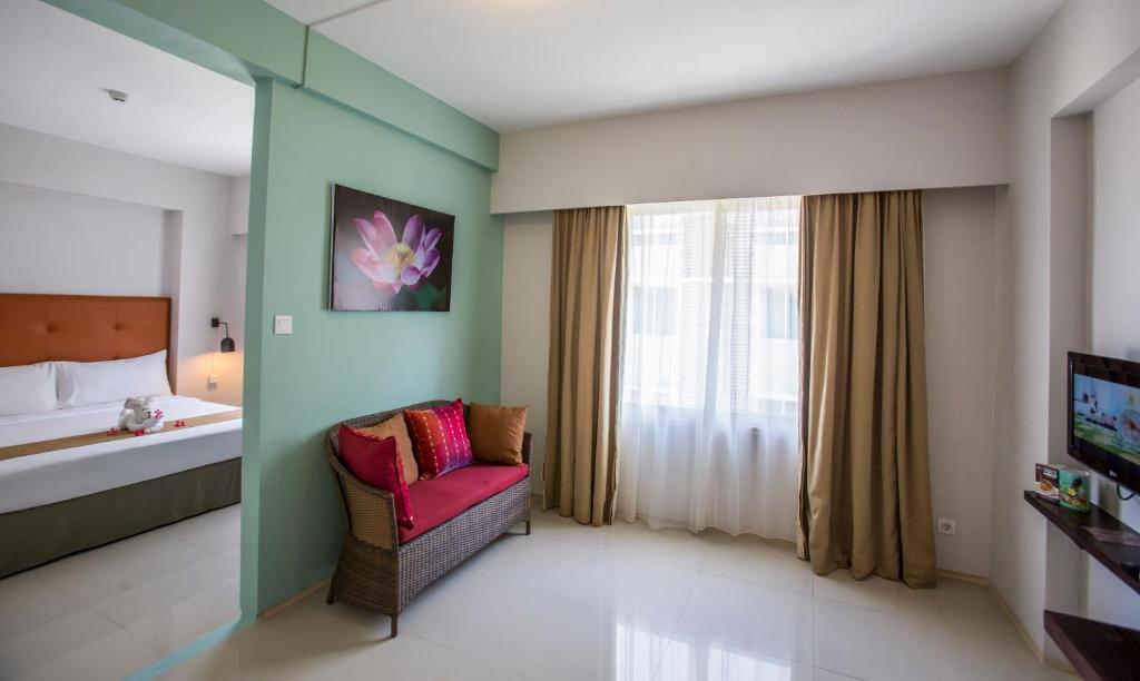 Postel nebo postele na pokoji v ubytování Ananta Legian Hotel