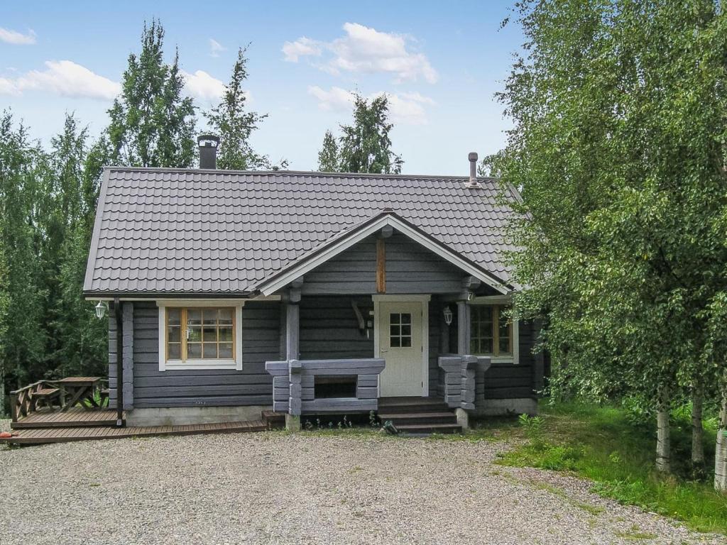 a small house with a bench in front of it at Holiday Home Juvan-vuokko by Interhome in Lahdenperä