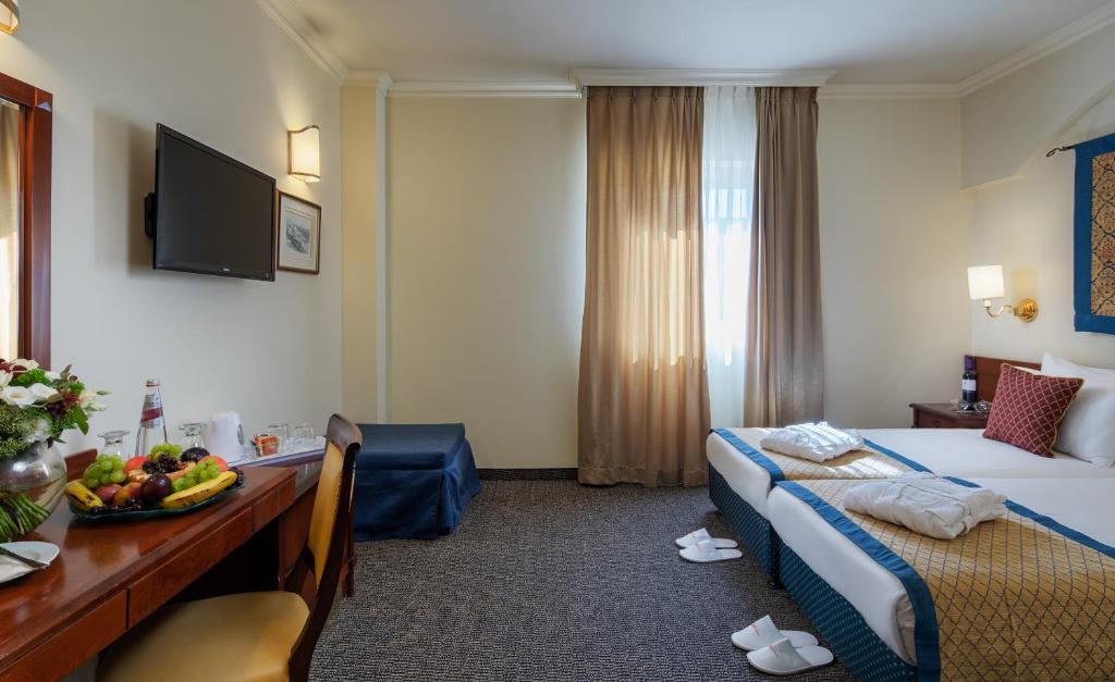 Postel nebo postele na pokoji v ubytování Prima Palace Hotel