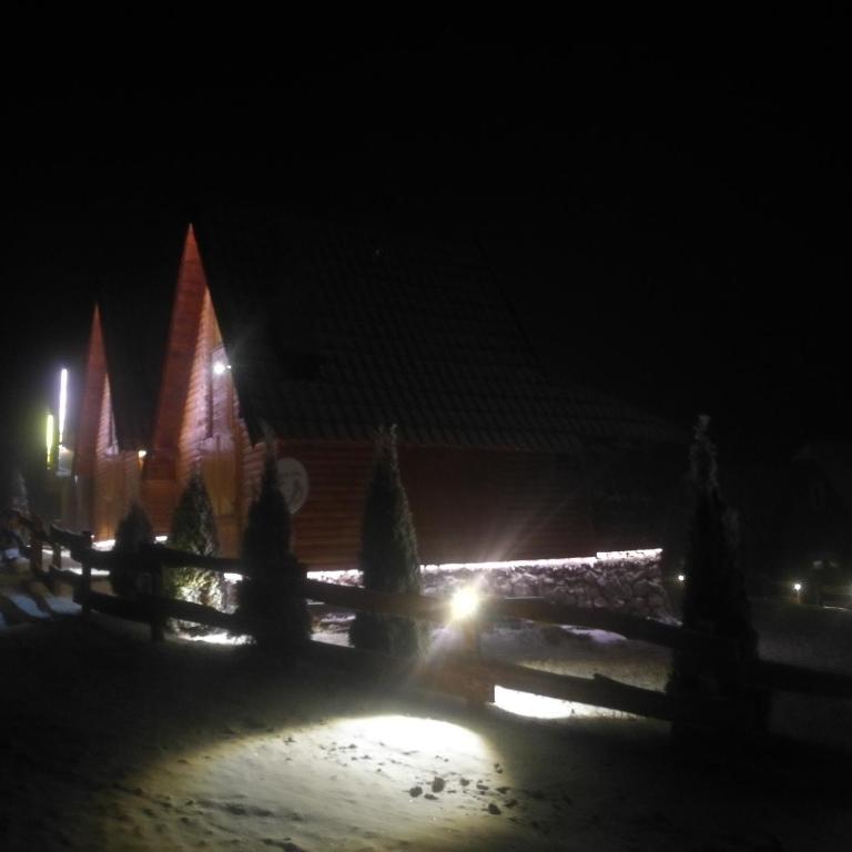 a building at night with a fence and lights at Lodge Nagramak in Sekulić 