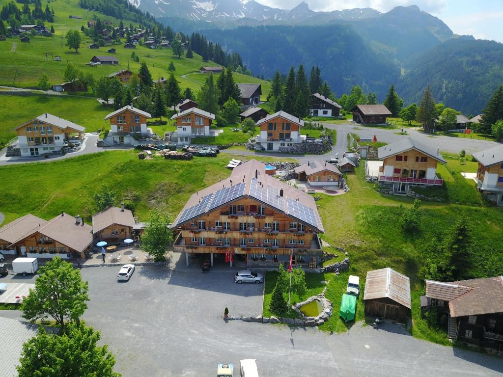 an aerial view of a large building in a village at Chemihüttli Apartments Axalp in Axalp