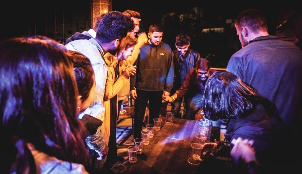 a group of people standing around a table with wine glasses at Hoztel Jaipur in Jaipur