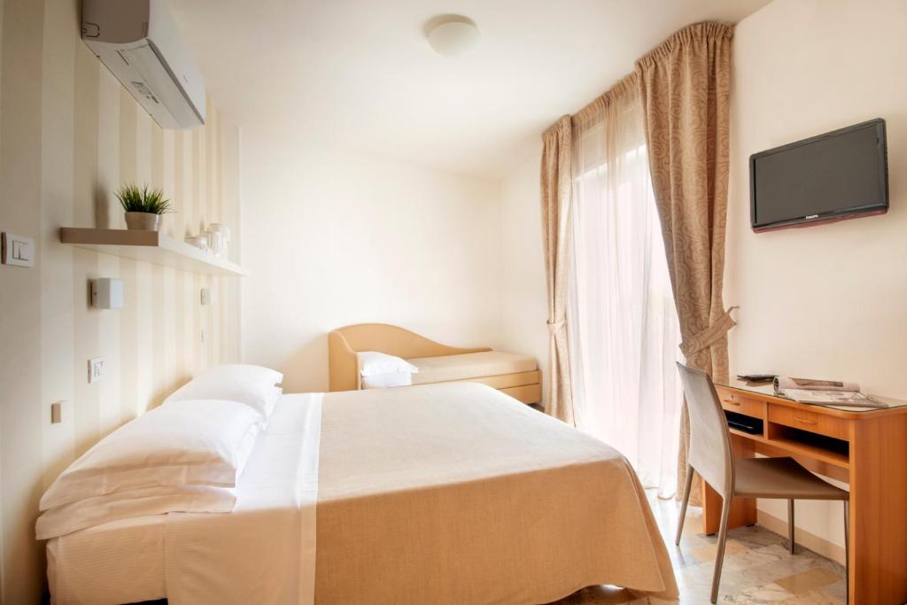 Postel nebo postele na pokoji v ubytování Hotel Bernard