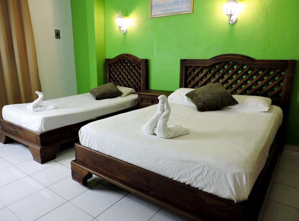 Postel nebo postele na pokoji v ubytování Hotel Valladolid