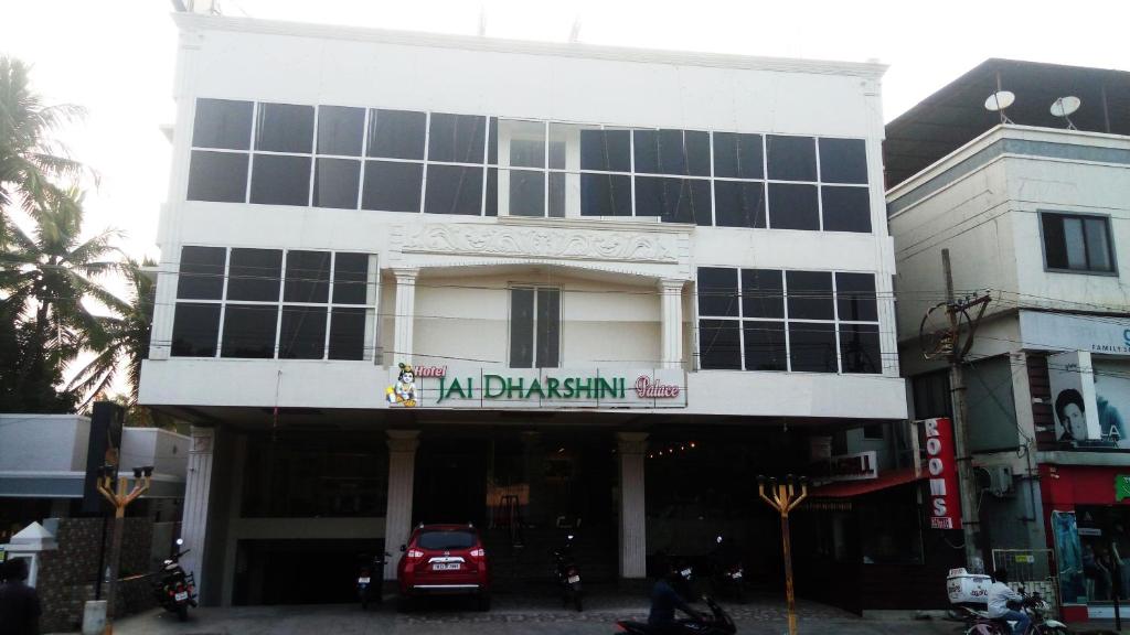 a large white building with a sign on it at Hotel Jaidharshini Palace in Kumbakonam