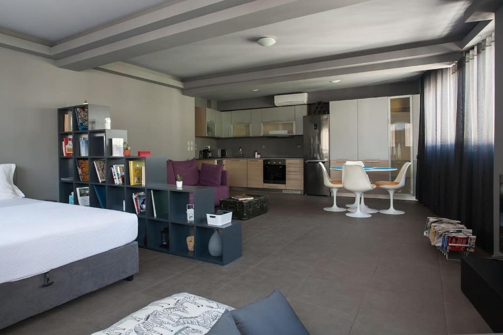 a bedroom with a bed and a living room and a kitchen at Boutique Apartment in Athens Center in Athens