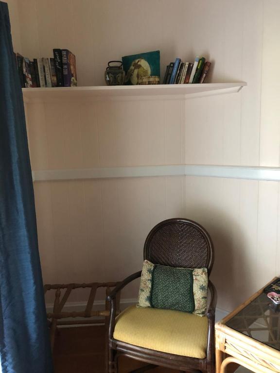 a wicker chair with a pillow sitting in a room at Old Hawaiian Bed and Breakfast in Hilo