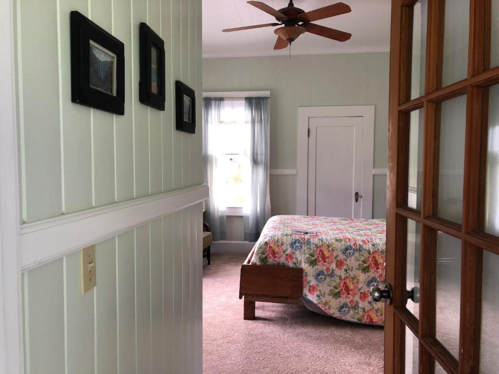 a bedroom with a bed and a ceiling fan at Old Hawaiian Bed and Breakfast in Hilo