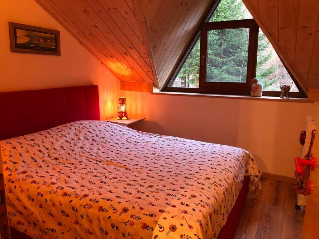 a bedroom with a bed and a window at Casa Margherita in Tarvisio