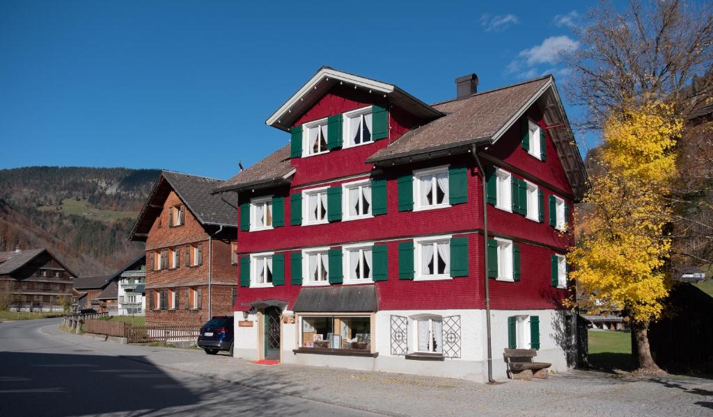 a large red and white building on a street at Alps Romantik in Mellau