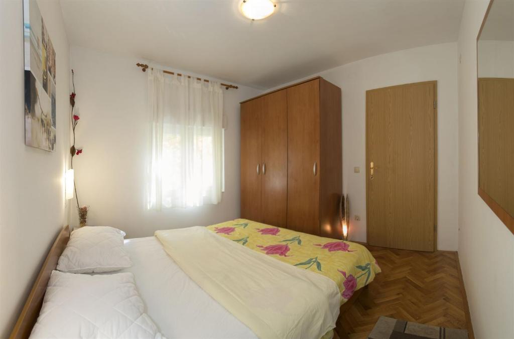 Postel nebo postele na pokoji v ubytování Apartments Gudelj