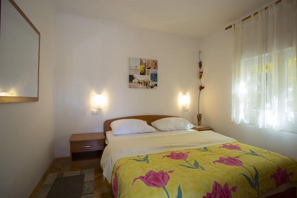 Postel nebo postele na pokoji v ubytování Apartments Gudelj