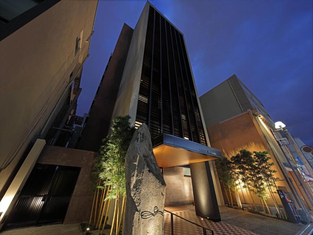 a tall building with a statue in front of it at Hotel Great Morning in Fukuoka