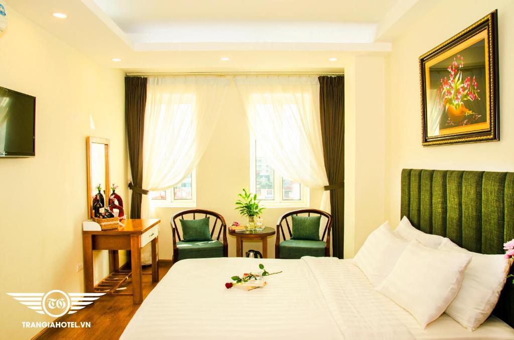 a hotel room with a bed and a table and chairs at Gia Loc Hotel in Hanoi