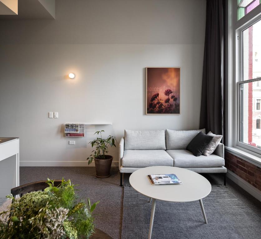 a living room with a couch and a table at The Chamberson in Dunedin