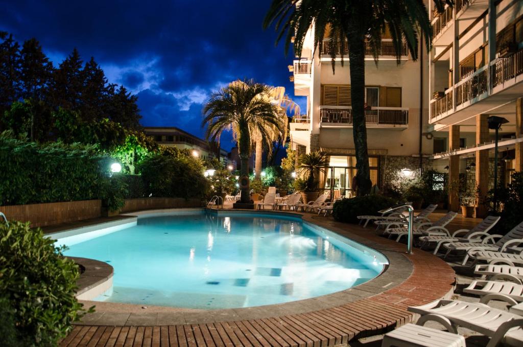 a swimming pool in a hotel at night at Grand Hotel Tamerici & Principe in Montecatini Terme