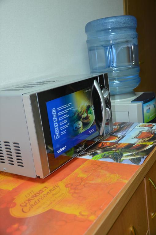 a microwave sitting on top of a table at Hotel Trias in Kyiv
