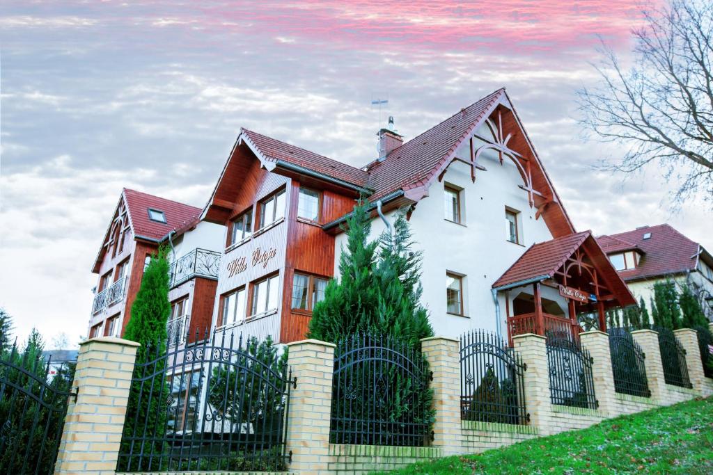 a large house with a fence in front of it at Willa Ostoja in Świeradów-Zdrój