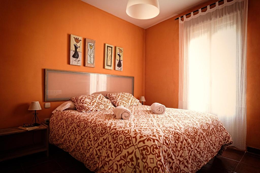a bedroom with a bed with two pillows on it at Casa La Alegria De La Alcarria II in Sigüenza