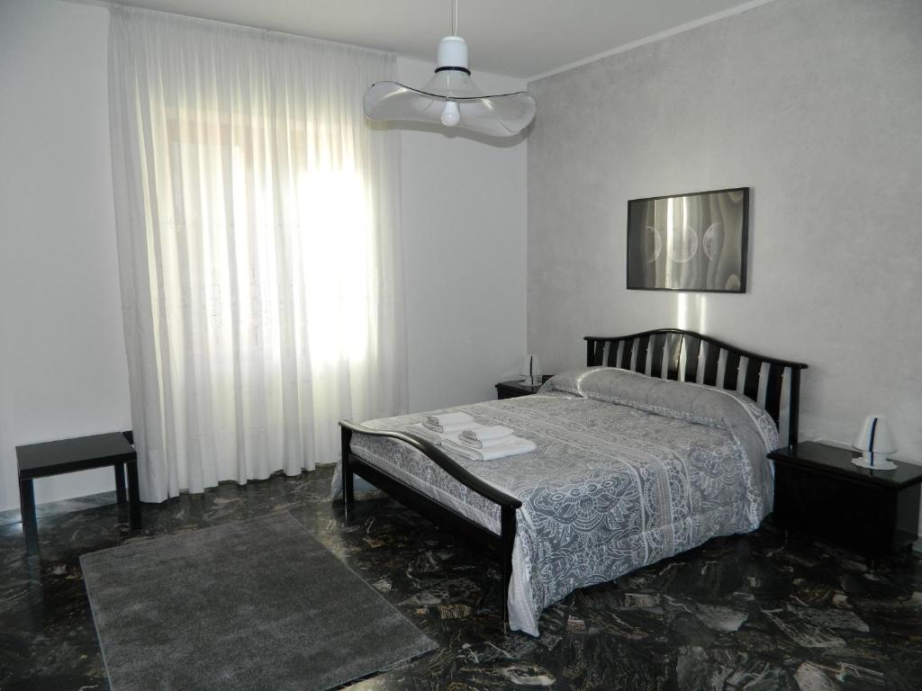 a bedroom with a bed and a large window at B&B SAN PIO in Pellezzano