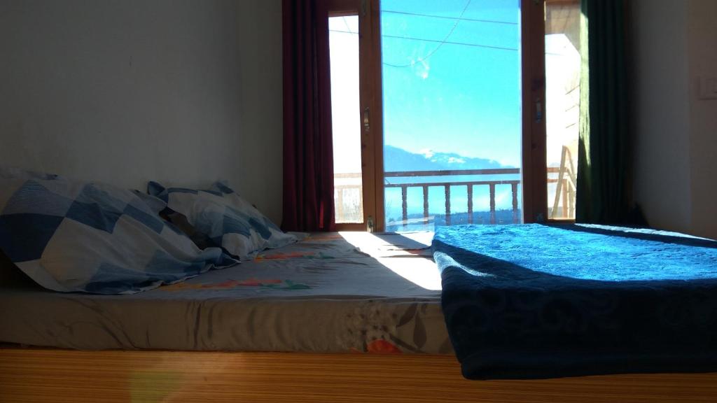 Postel nebo postele na pokoji v ubytování Sunface Homestay