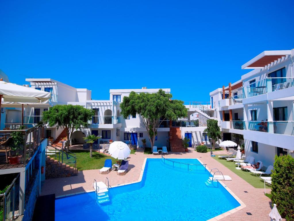 an image of a swimming pool at a hotel at Minos Village in Agia Marina Nea Kydonias