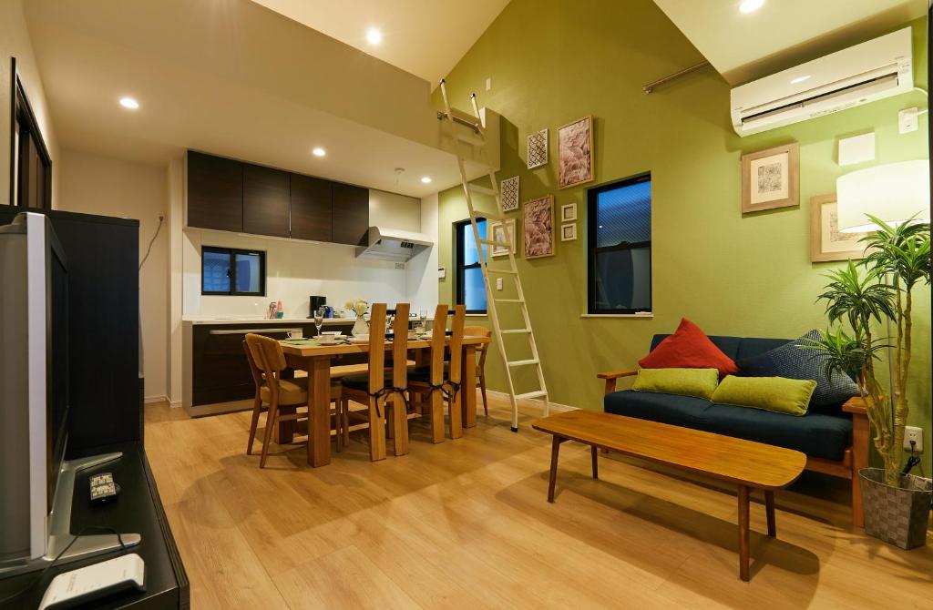 a kitchen and living room with a couch and a table at Asakusa Skytree Luxury House in Tokyo