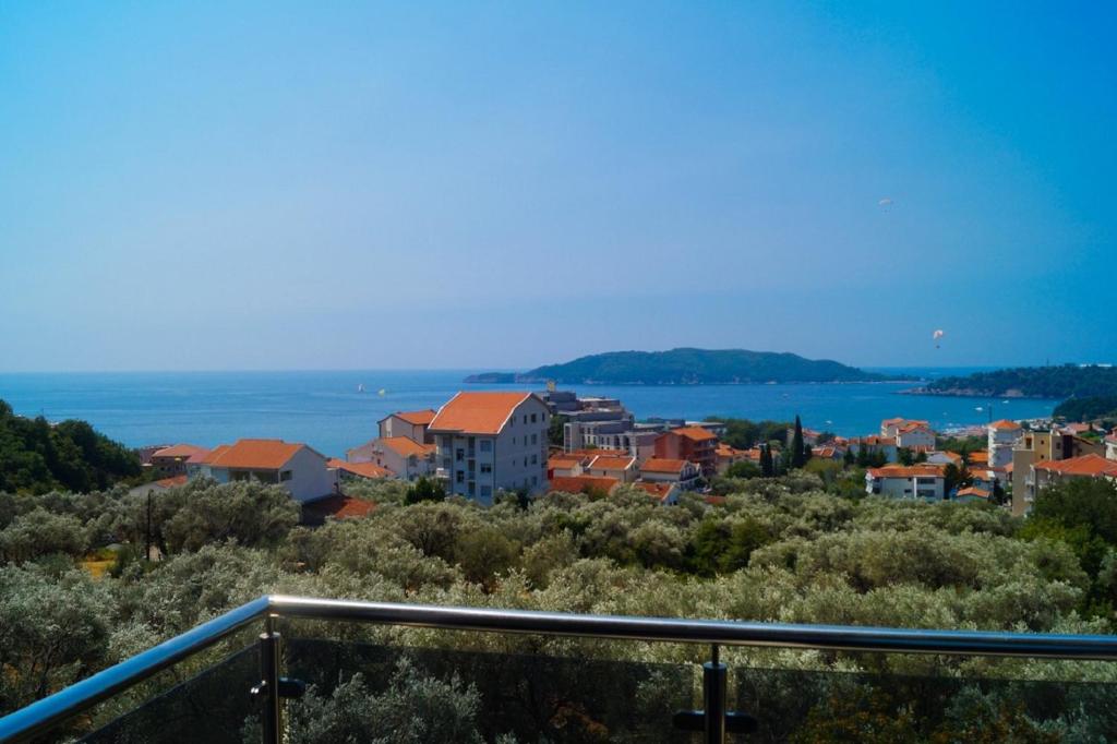 a view of a town with the water and buildings at Apartment Olive Montenegro KO Becici in Budva