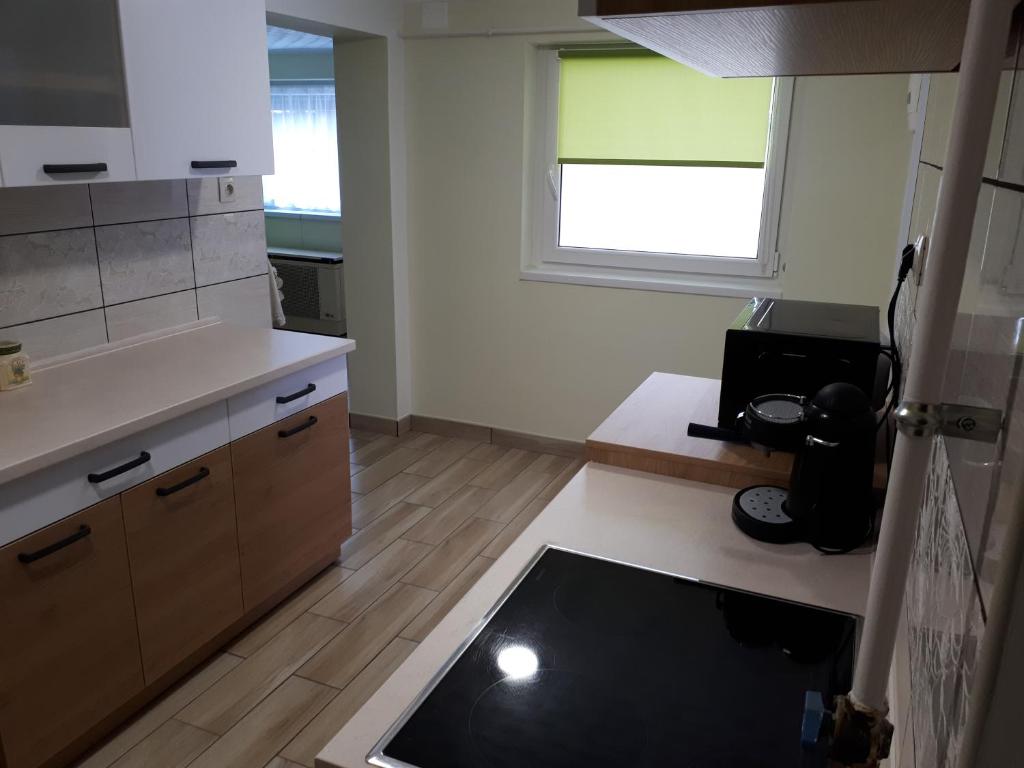 A kitchen or kitchenette at Csóka Apartman Pápa