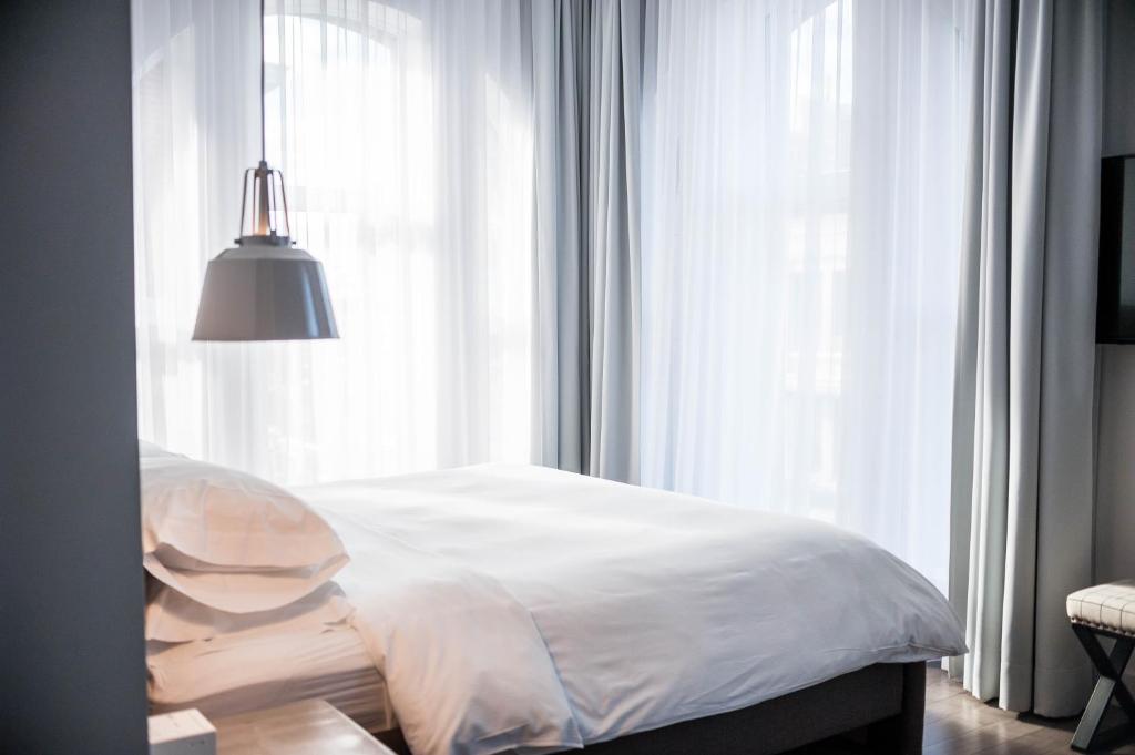 Postel nebo postele na pokoji v ubytování Hotel Oui GO!