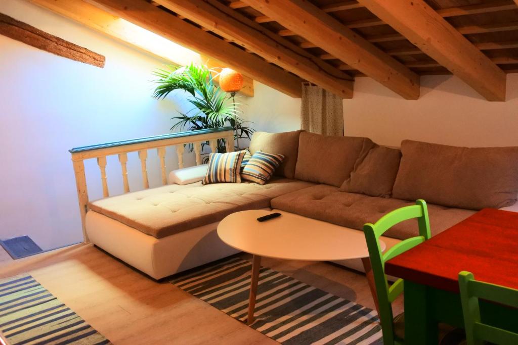 a living room with a couch and a table at Apartments Jago in Piran