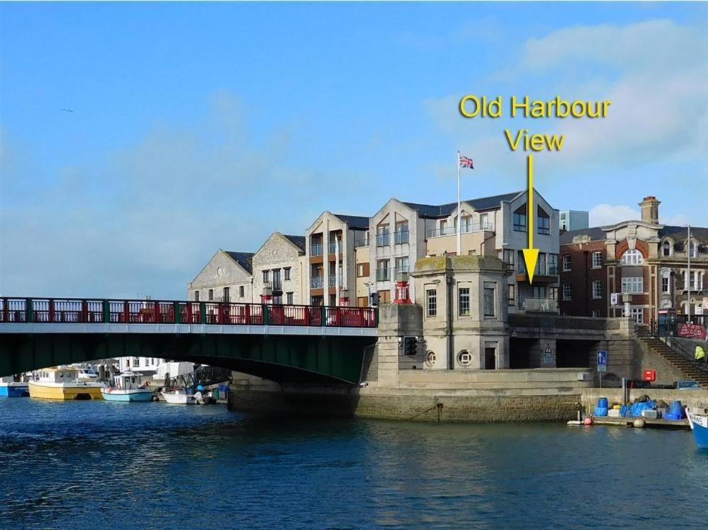 a bridge over a body of water with buildings at Old Harbour View in Weymouth