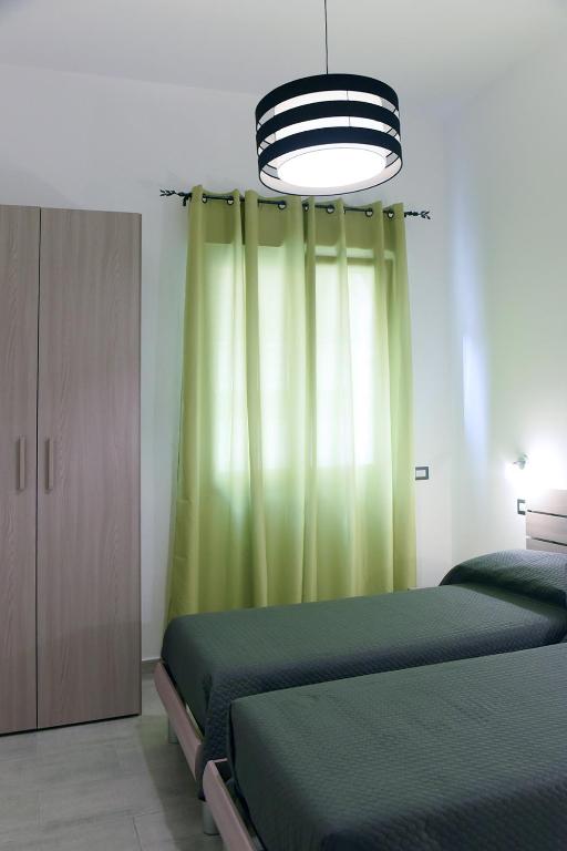 Łóżko lub łóżka w pokoju w obiekcie Kero House