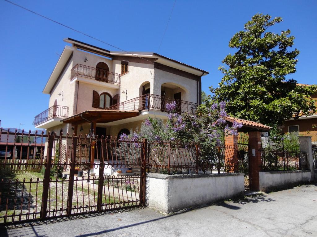 a house with a fence in front of it at B&B La Magnolia in Sulmona