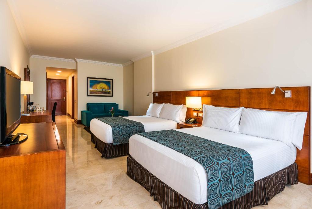 Una cama o camas en una habitación de Hotel Dann Carlton Bucaramanga
