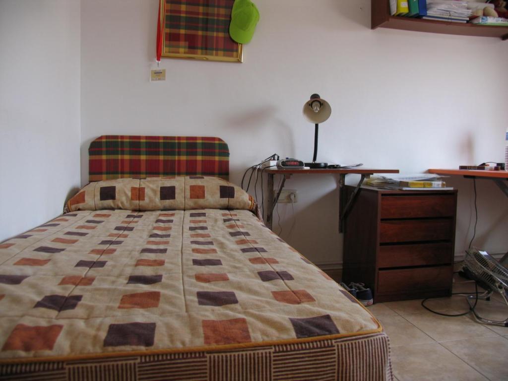 a bedroom with a bed and two desks in it at Residencia Universitaria Reuniver Burjassot in Benimamet