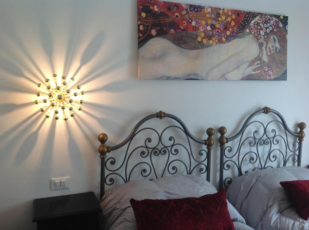 a bedroom with a bed and a mirror on the wall at Corte Del Gallo in Corniglia