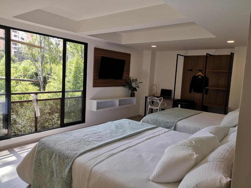 Postel nebo postele na pokoji v ubytování Foresta Hotel