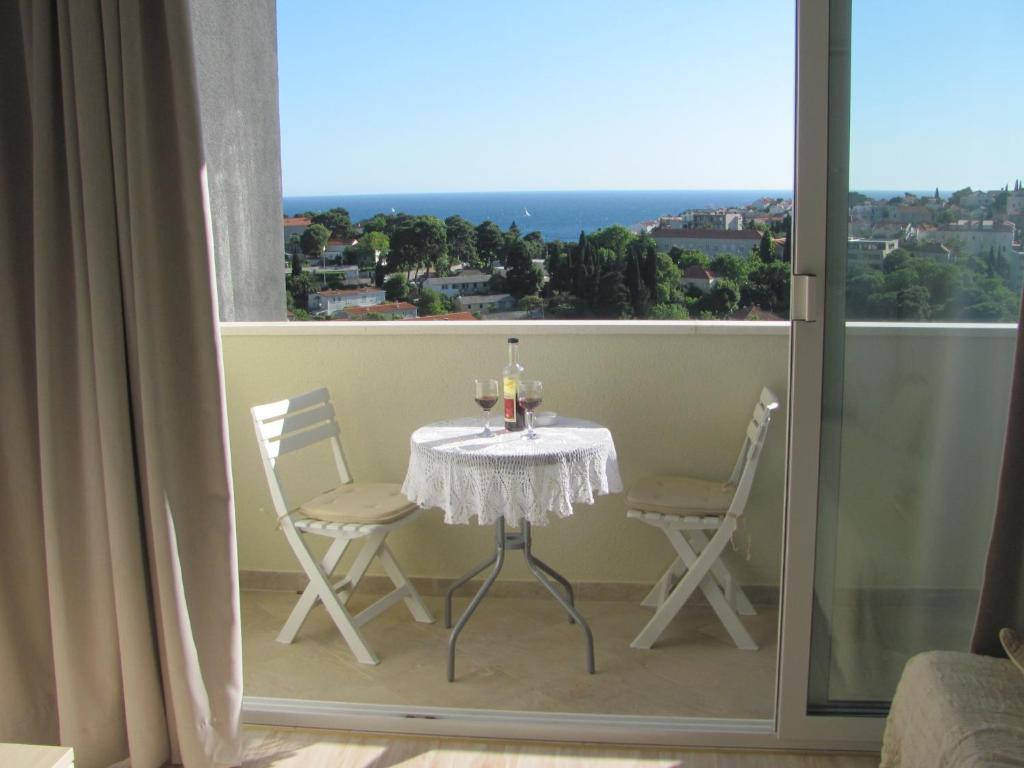 a table and chairs on a balcony with a view at Studio Tamara in Dubrovnik